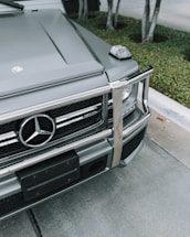 black Mercedes-Benz SUV parked near tree