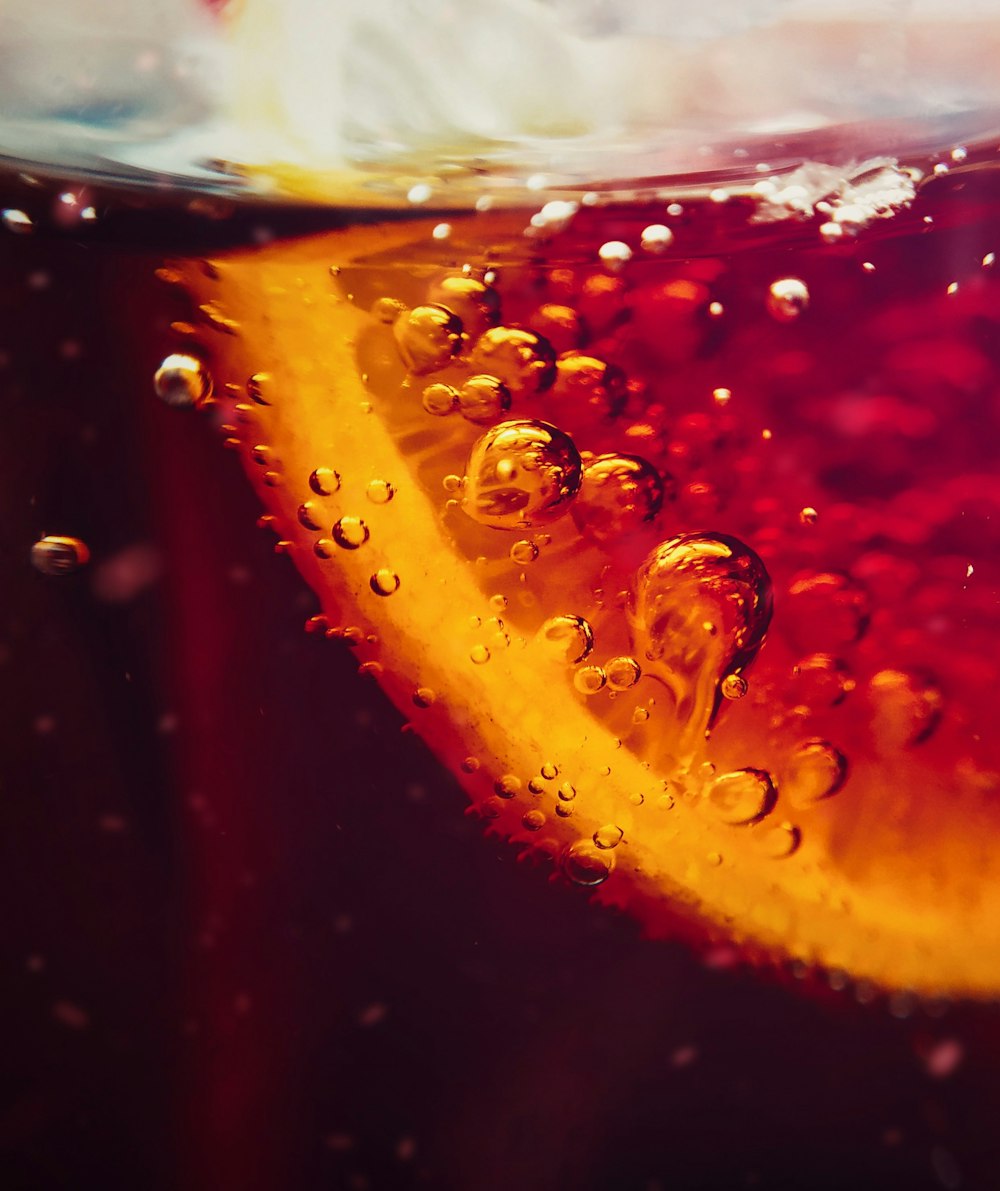 a close up of a slice of orange in water