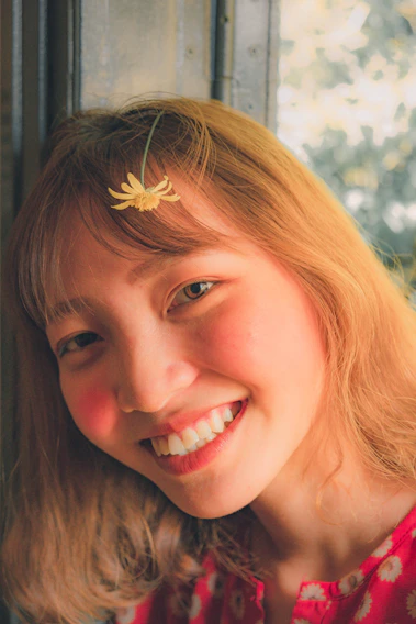 A warm, candid photo of Agnieszka smiling gently in a sunlit garden.