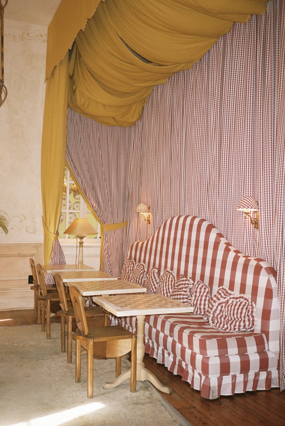 white and orange couch near dining tables and chairs