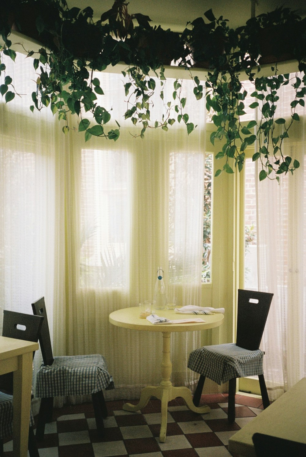 a room with a checkered floor and a table and chairs