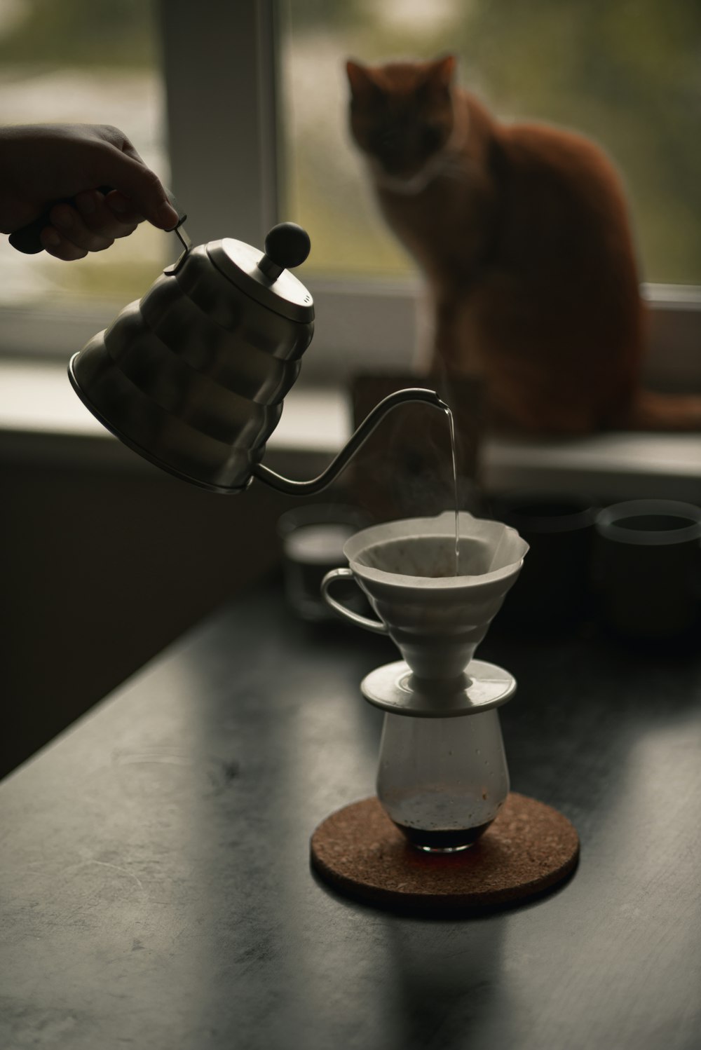pouring liquid on white ceramic cup