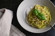 Freshly made spaghetti with a vibrant basil pesto sauce.