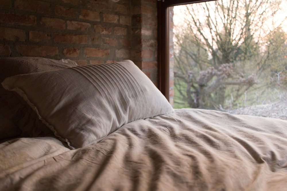 pillow on bed near window