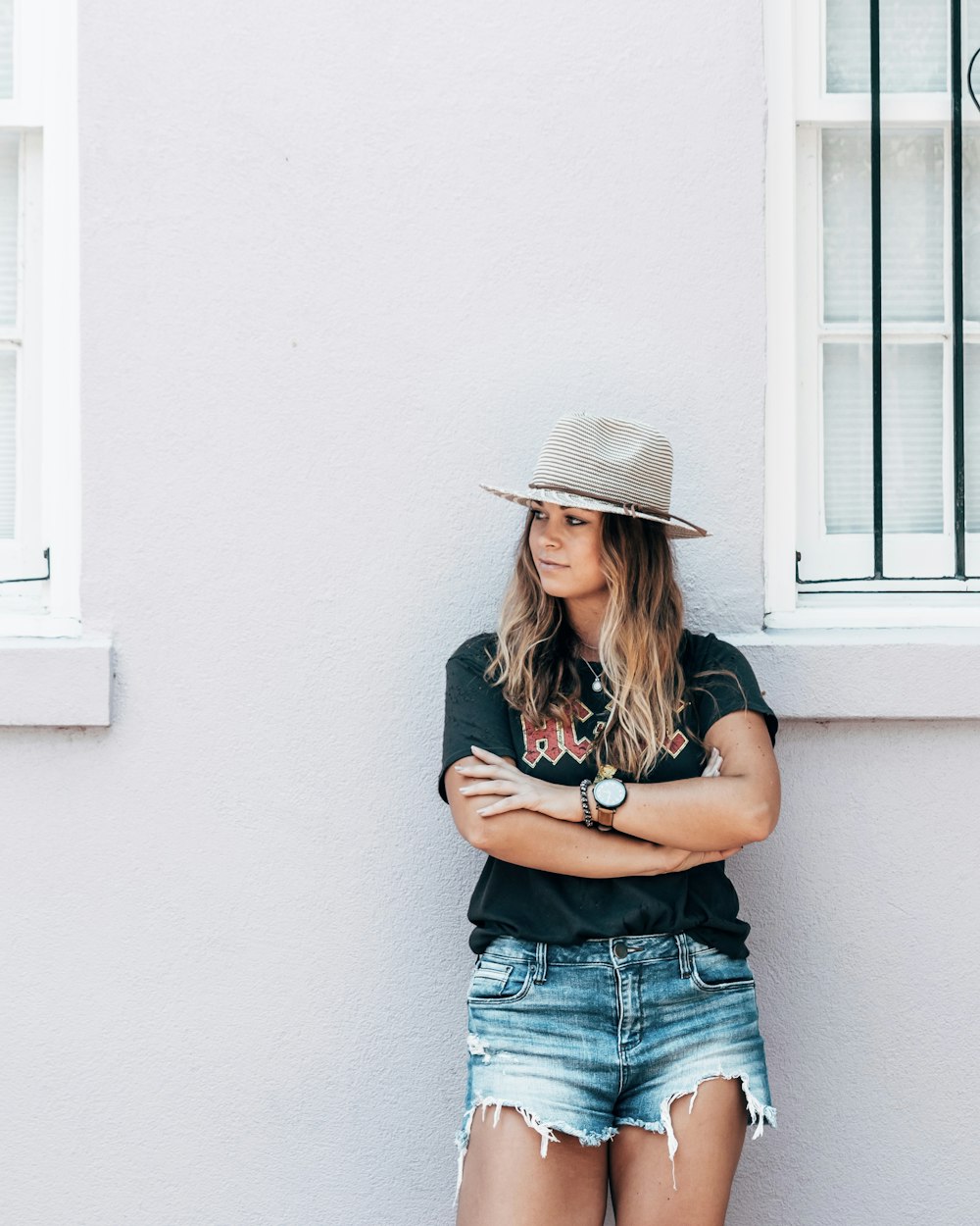 woman leaning on concrete wall at daytime