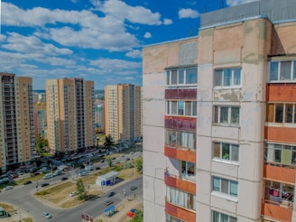 High-rise city apartment complex with bustling streets below.