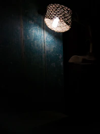 A pastoral woven wall lamp adding texture and warmth to a simple wall.