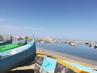 A serene morning scene of a traditional Malaysian fishing village with boats gently resting on calm waters.
