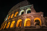 A vibrant photo of Verona's historic Arena at sunset, glowing warmly.