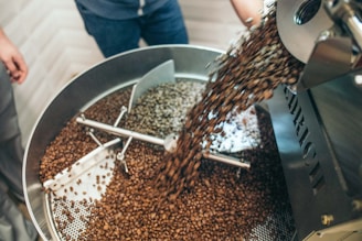 coffee machine pouring coffee in metal mixing container