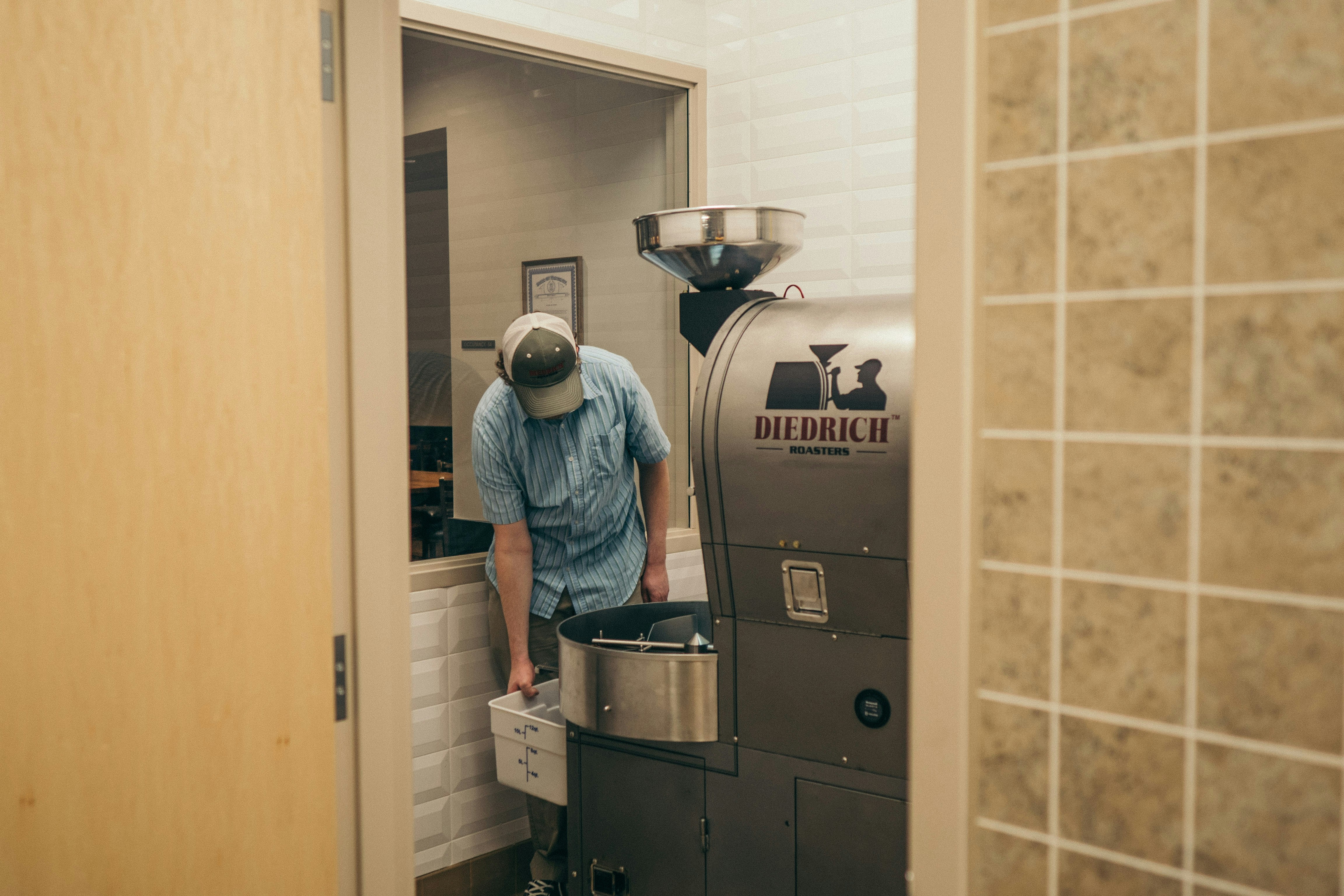 man looking at Diedrich machine inside room