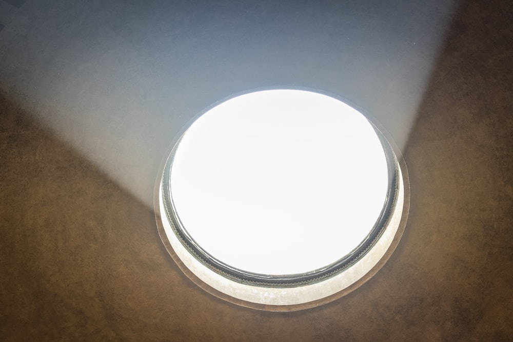 a round window with a light shining through it