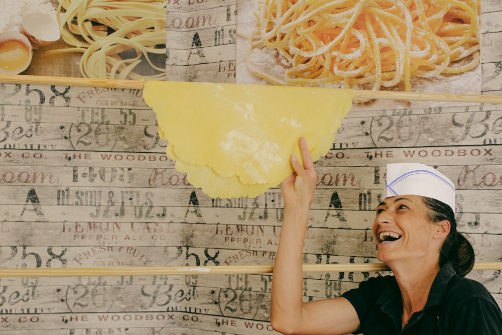laughing woman holding a pastry dough