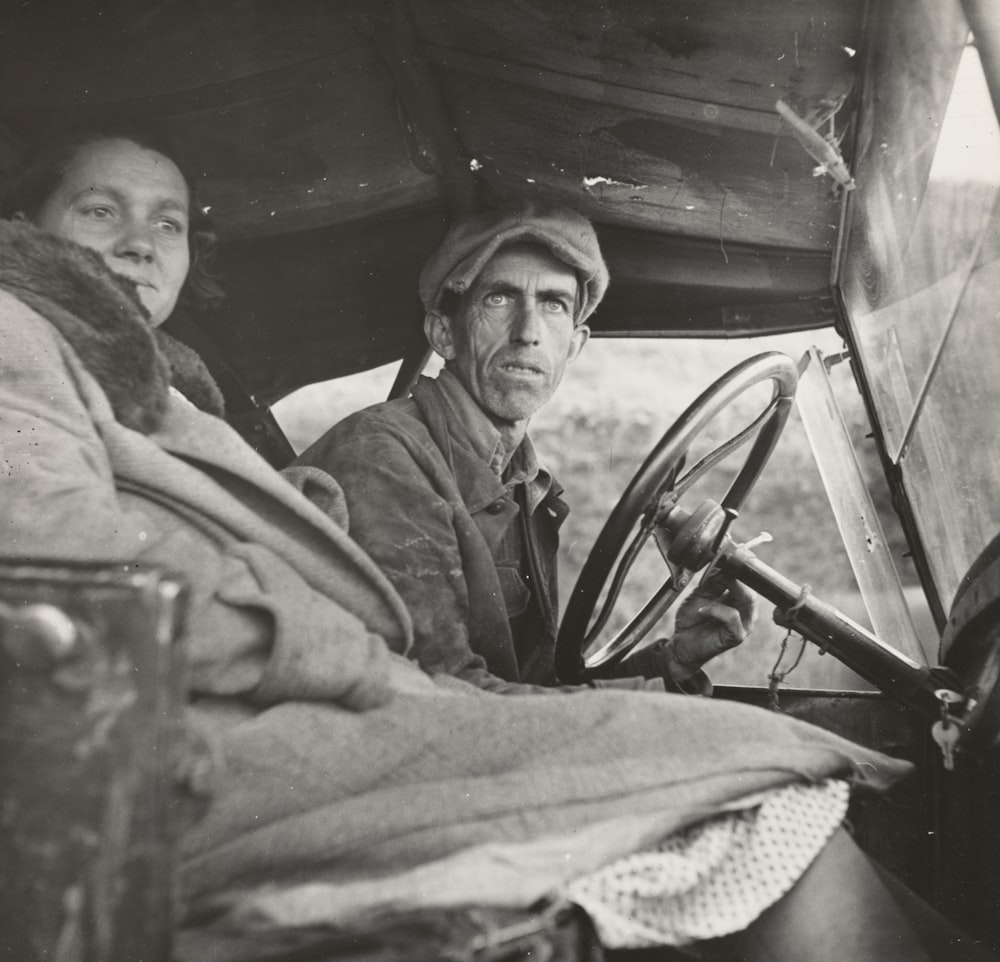 two man and woman sitting inside car during day