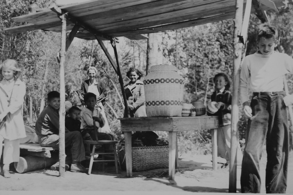 grayscale photography of people near gazebo