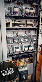 Modern circuit breakers installed inside a sleek switch cabinet with blue lighting.