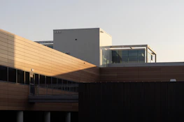 Finished modern building exterior featuring clean lines and a warm coffee-colored facade.
