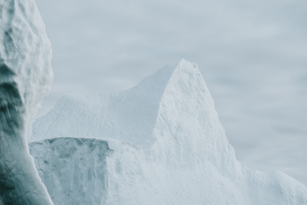 a large iceberg in the middle of a body of water