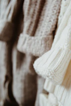 Close-up of handmade pet collars and sweaters with vibrant colors and textures.