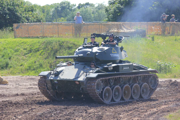 A tank commander in military gear analyzing a digital map with AI interface in the background.