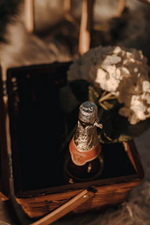A cozy scene of a couple enjoying a romantic gift basket with artisanal cheeses and a bottle of sparkling wine.