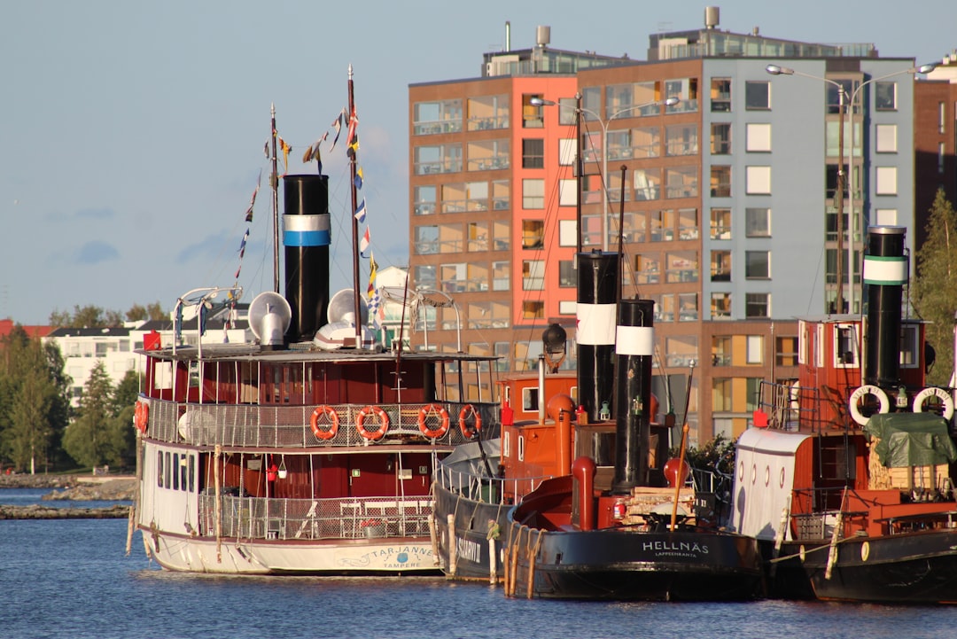 grey and red pasenger ship