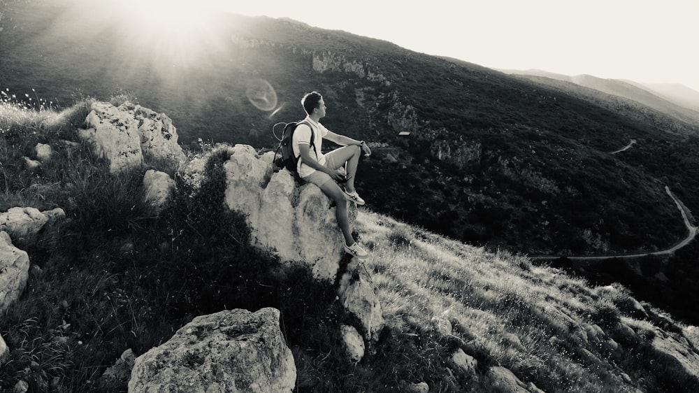 man sitting on rock