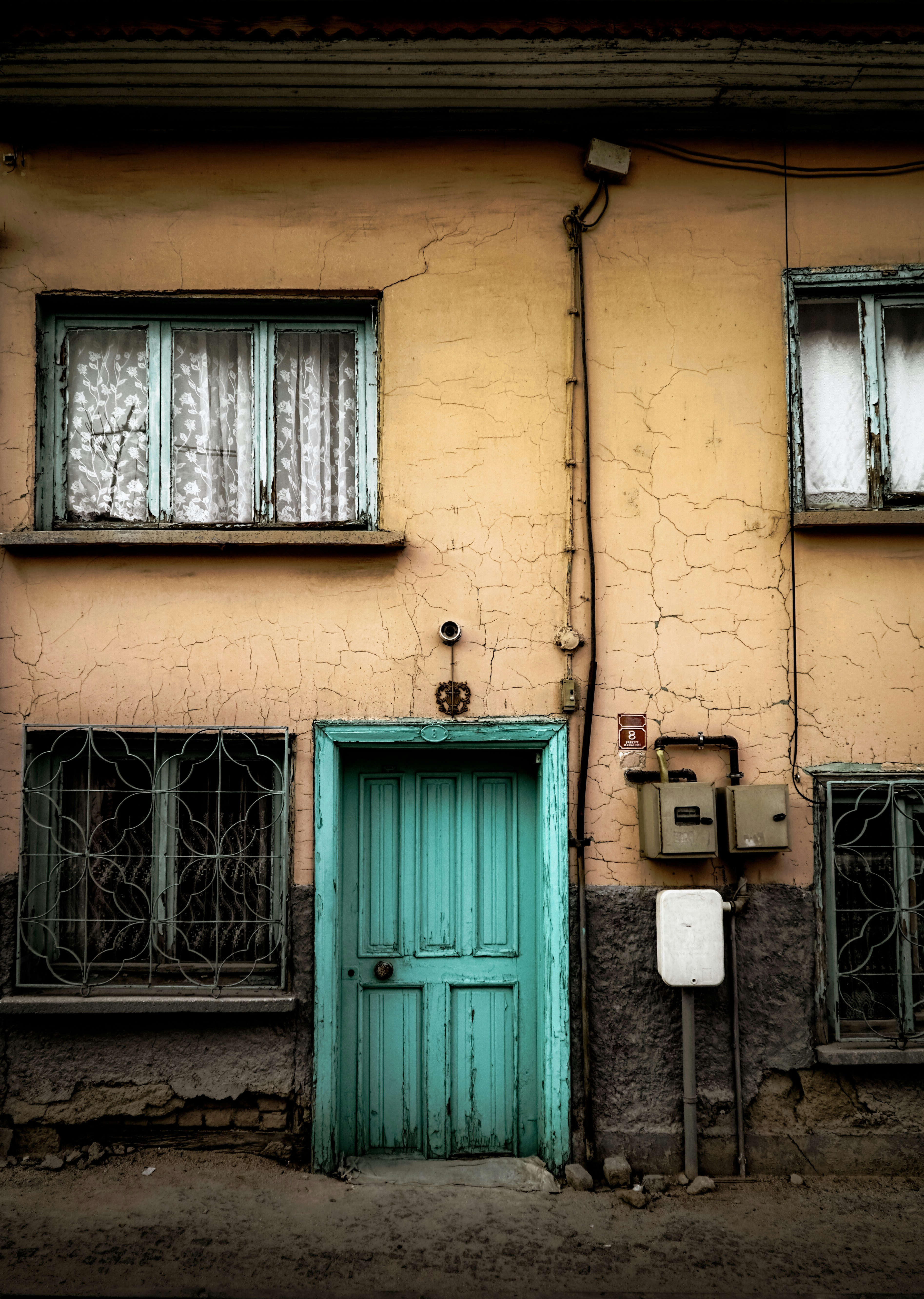 blue wooden door with gray metal chain link fence