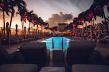 Cinematic shot of a luxury resort poolside at sunset with a sleek city skyline in the background.