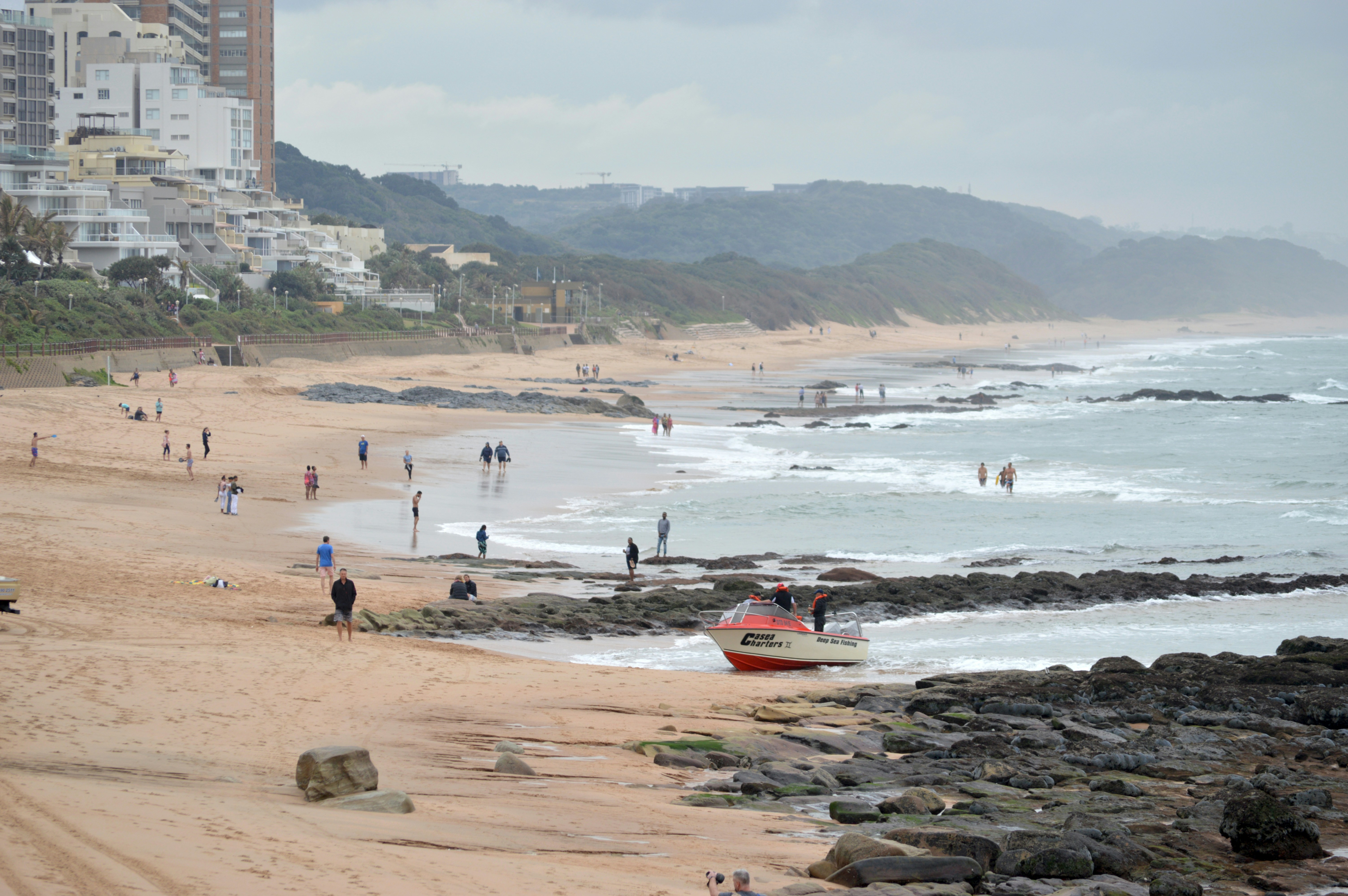 Vibrant crowd of tourists enjoying the sunny festive season on Durban's popular beachfront.