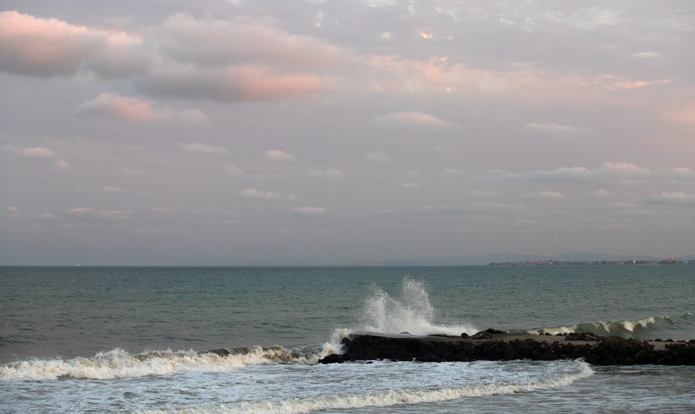 waves crashing on rock at shore