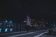 A candid shot of someone wearing a redfivefour cap while walking through a city street.