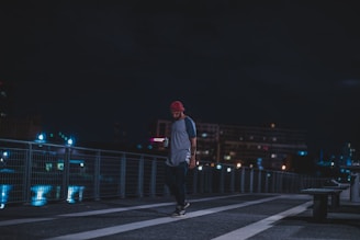 A candid shot of someone wearing a redfivefour cap while walking through a city street.