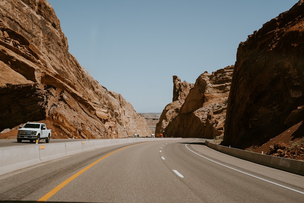 white pickup truck passing road during daytime