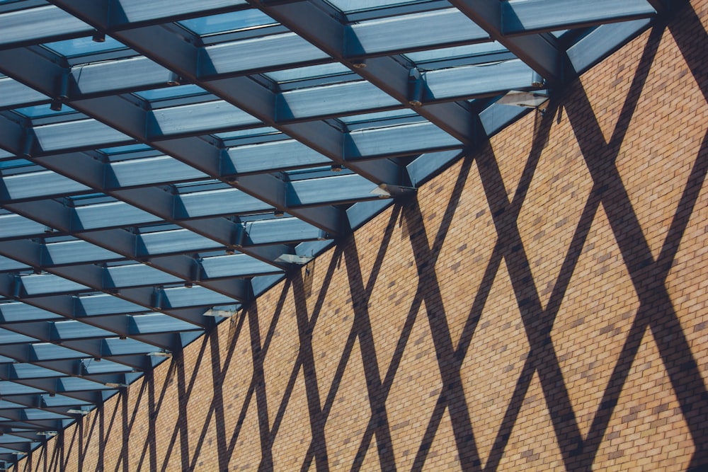 a brick building with a metal roof and blue windows