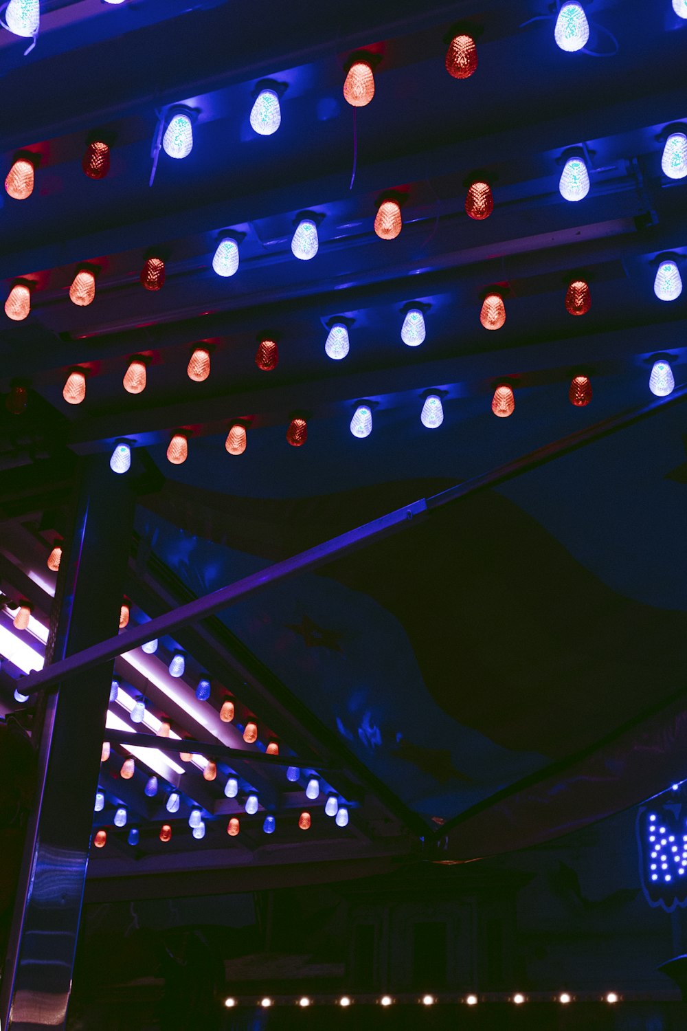 a group of lights hanging from the ceiling of a building