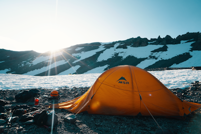 orange MSR tent near mountain