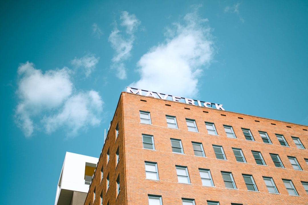 Maverick building under blue and white skies during daytime