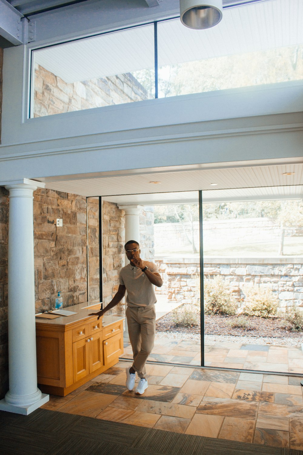 a man standing in front of a sink in a room