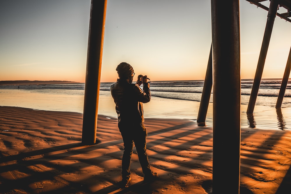 silhouette of person taking photo using DSLR camera