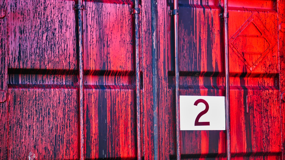 a red door with a white number two on it