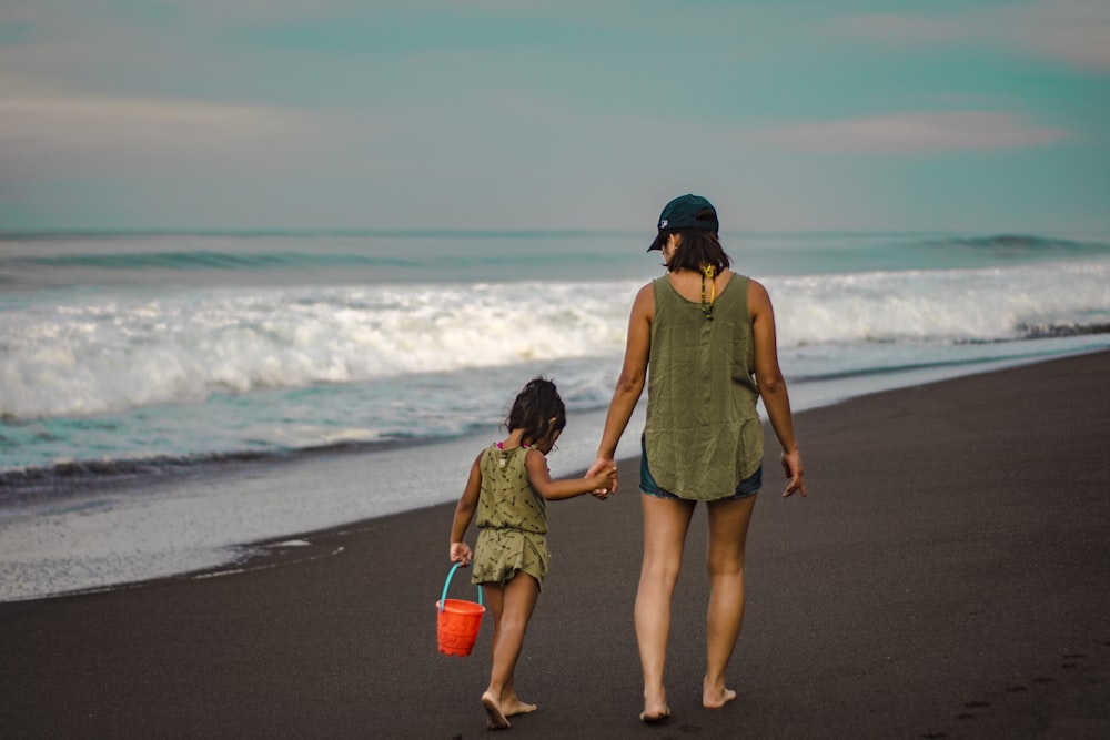 mother and daughter walking near hore