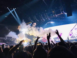 A concert crowd shot from afar, enhanced to reveal individual faces and instruments clearly.