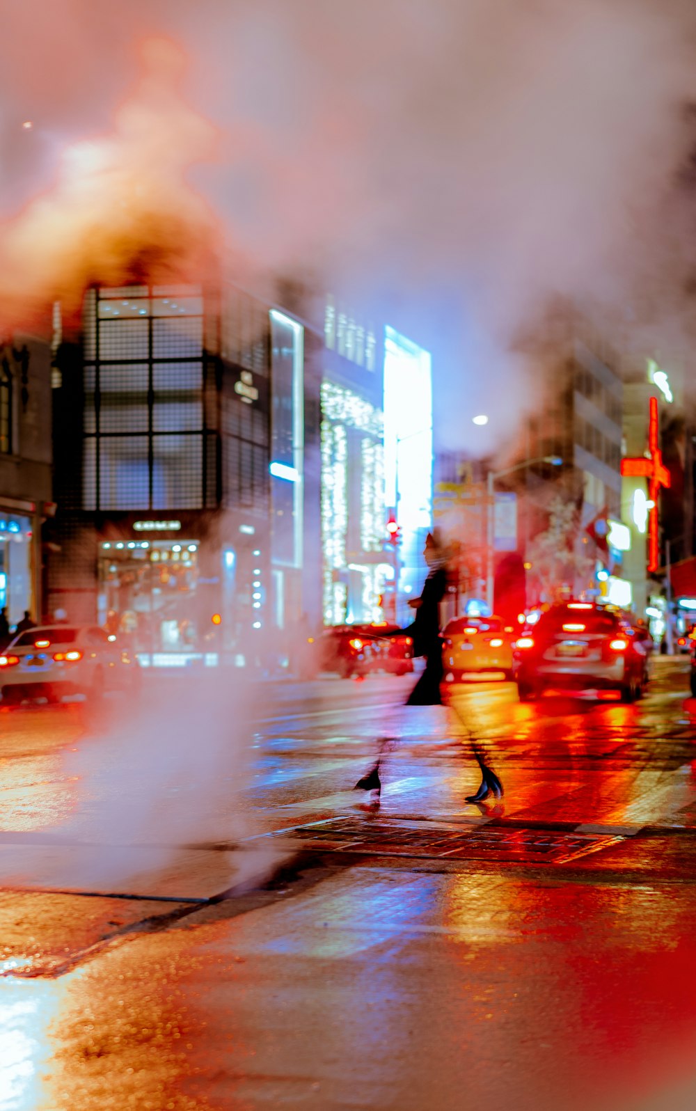 woman crossing on road at night time