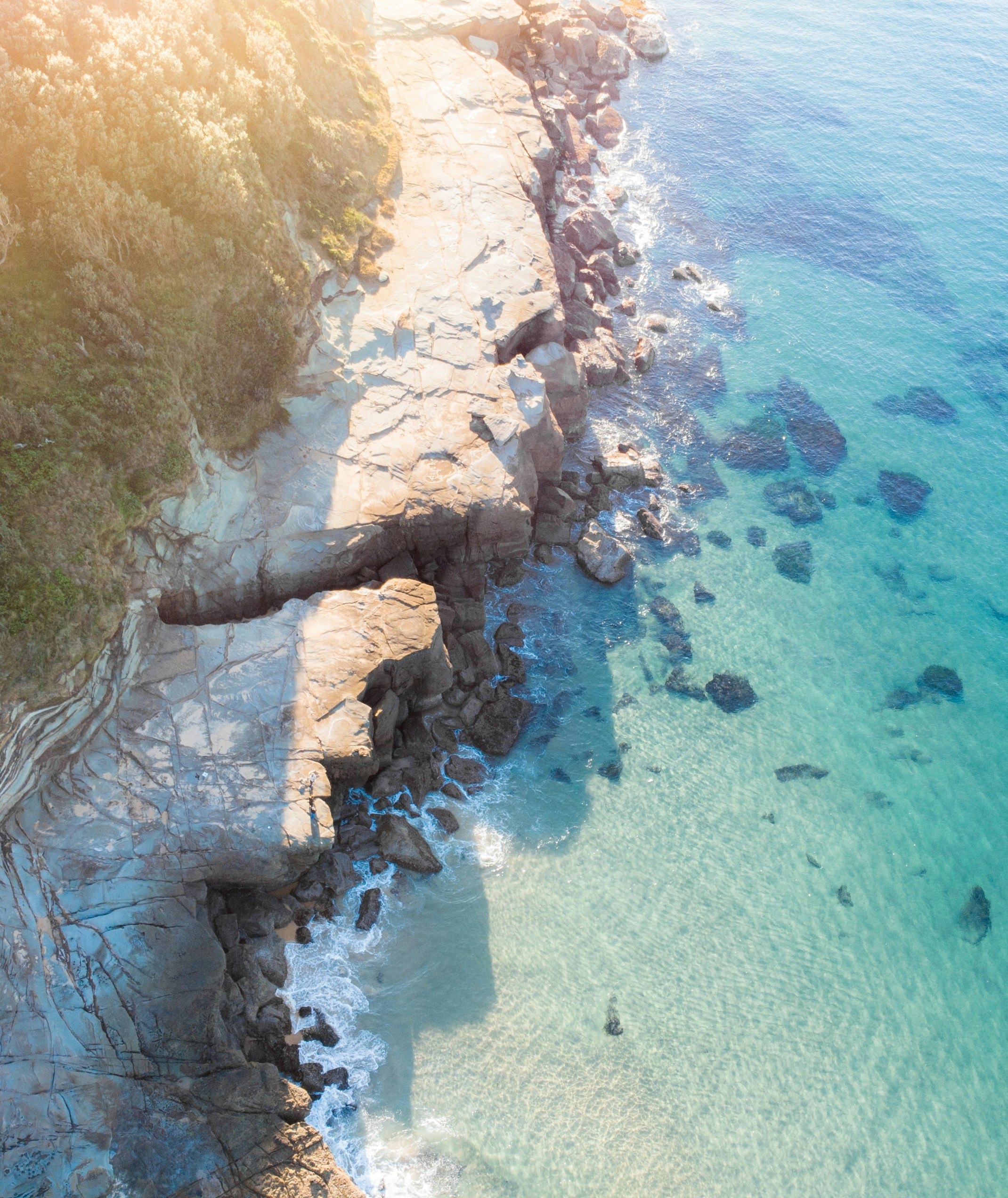 wide angle photography of seashore and cliff during daytime