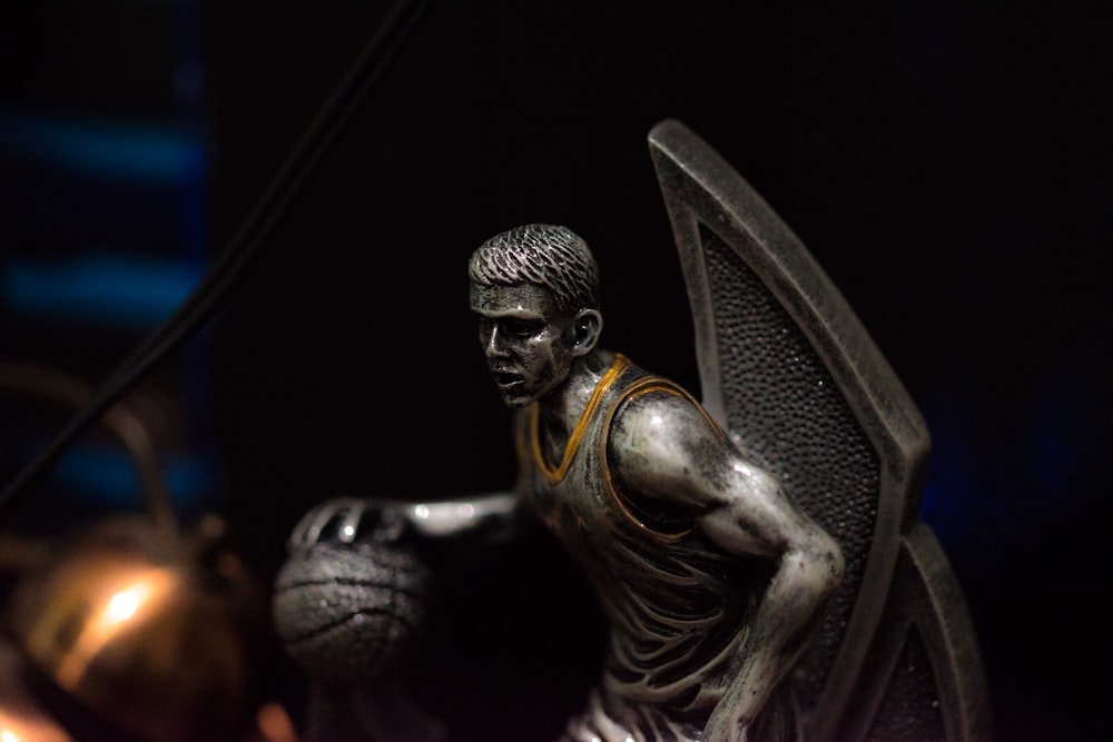 a statue of a basketball player holding a basketball