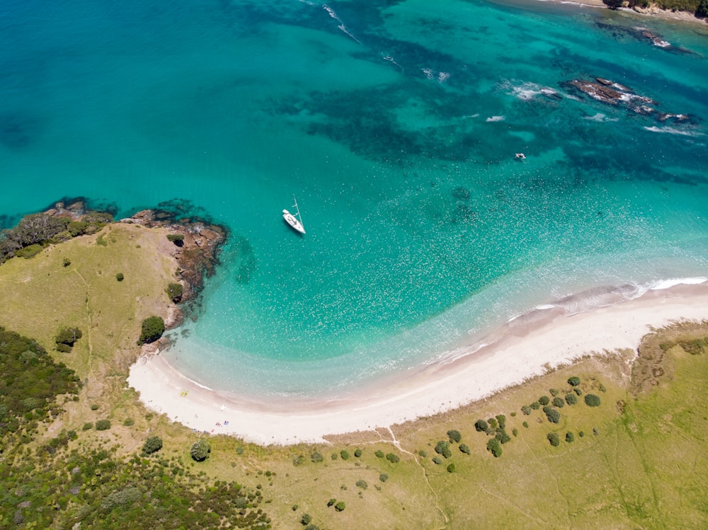 aerial photography of white boat on boat of water