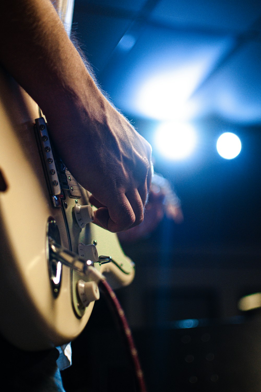 a close up of a person playing a guitar