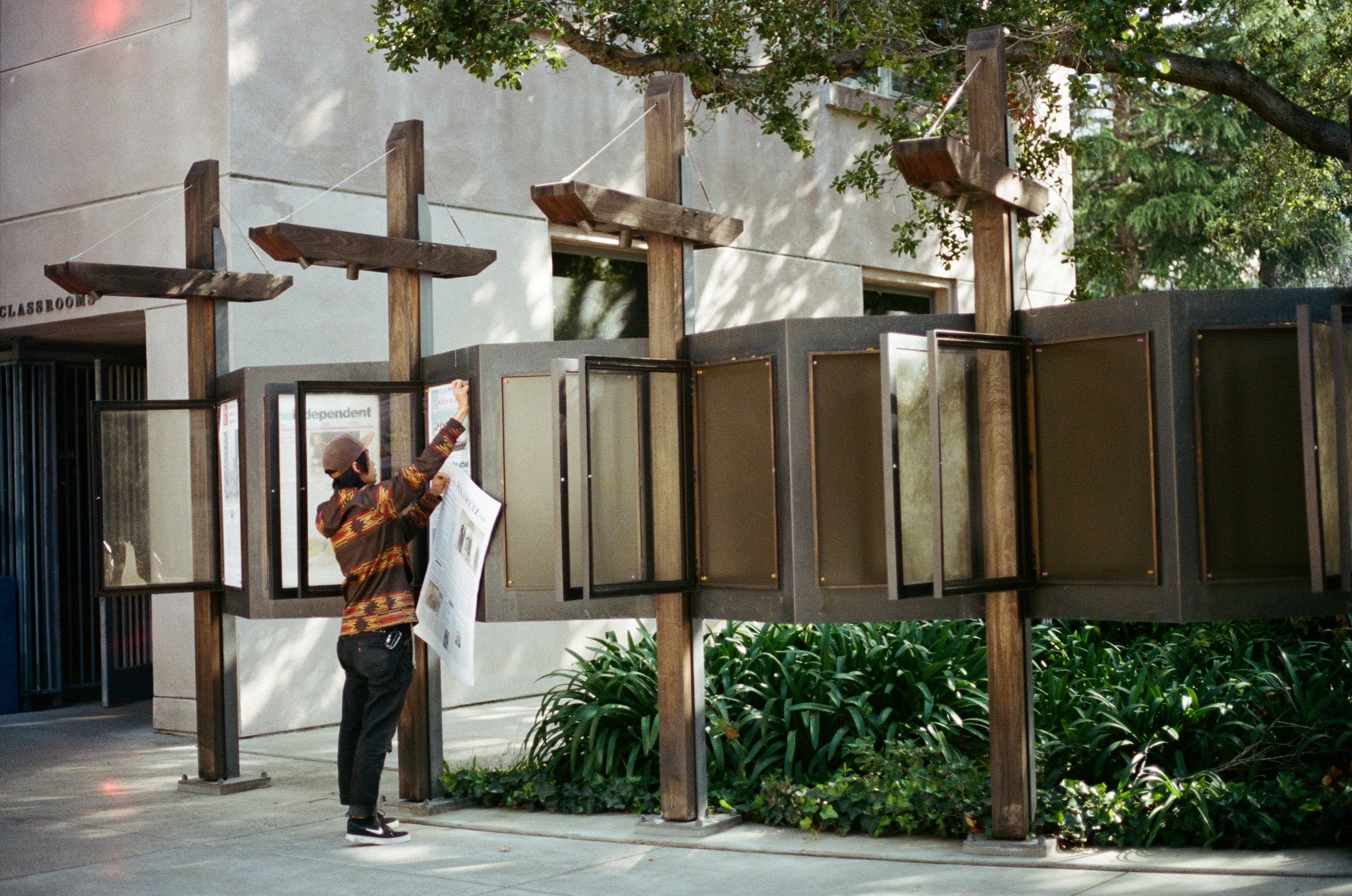 person standing beside concrete building during daytime
