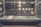 An old-fashioned control room panel filled with numerous analog dials, switches, and meters. The panel has labels such as 'Radiation', 'Reactor', and 'Interlocks', indicating its use in monitoring and controlling industrial or scientific processes. The design suggests mid-20th-century technology, with a utilitarian layout and a slight yellowed tint, giving it a vintage appearance.